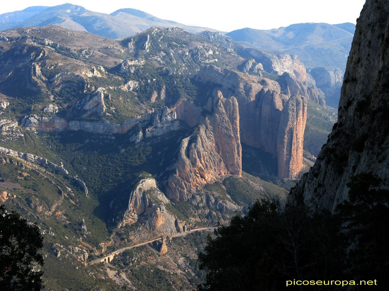 Los impresionantes Mallos de Riglos, para apreciar sus dimensiones hay que fijarse en la lénea horizontal bajo ellos, es la véa del tren, Pirineos de Huesca